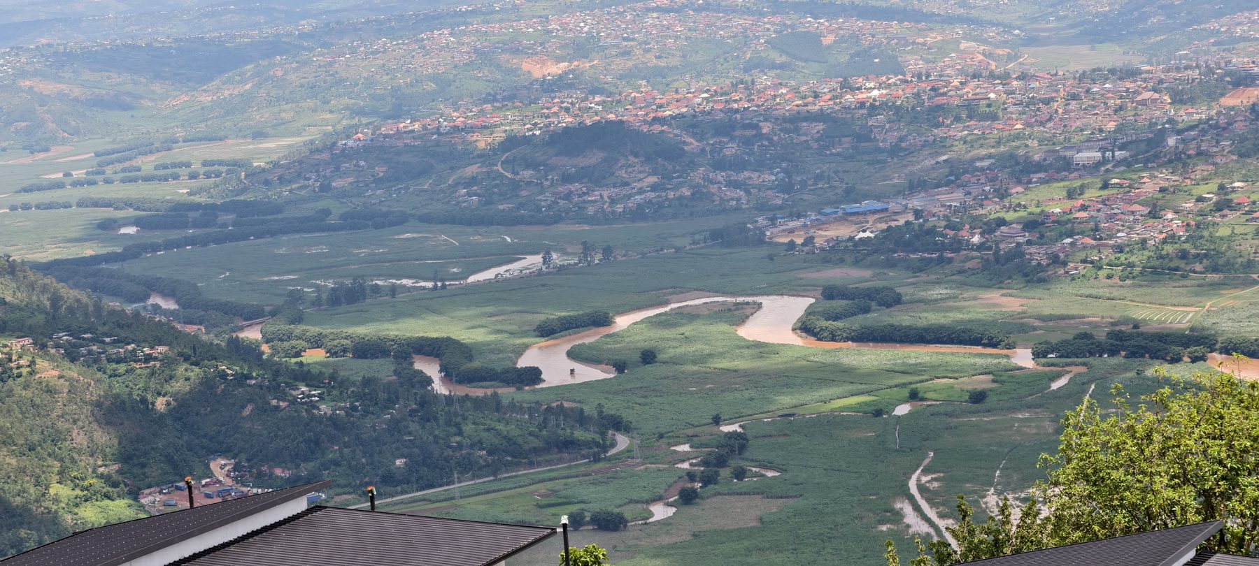 The Nyabarongo river winding through the valley below the ridge